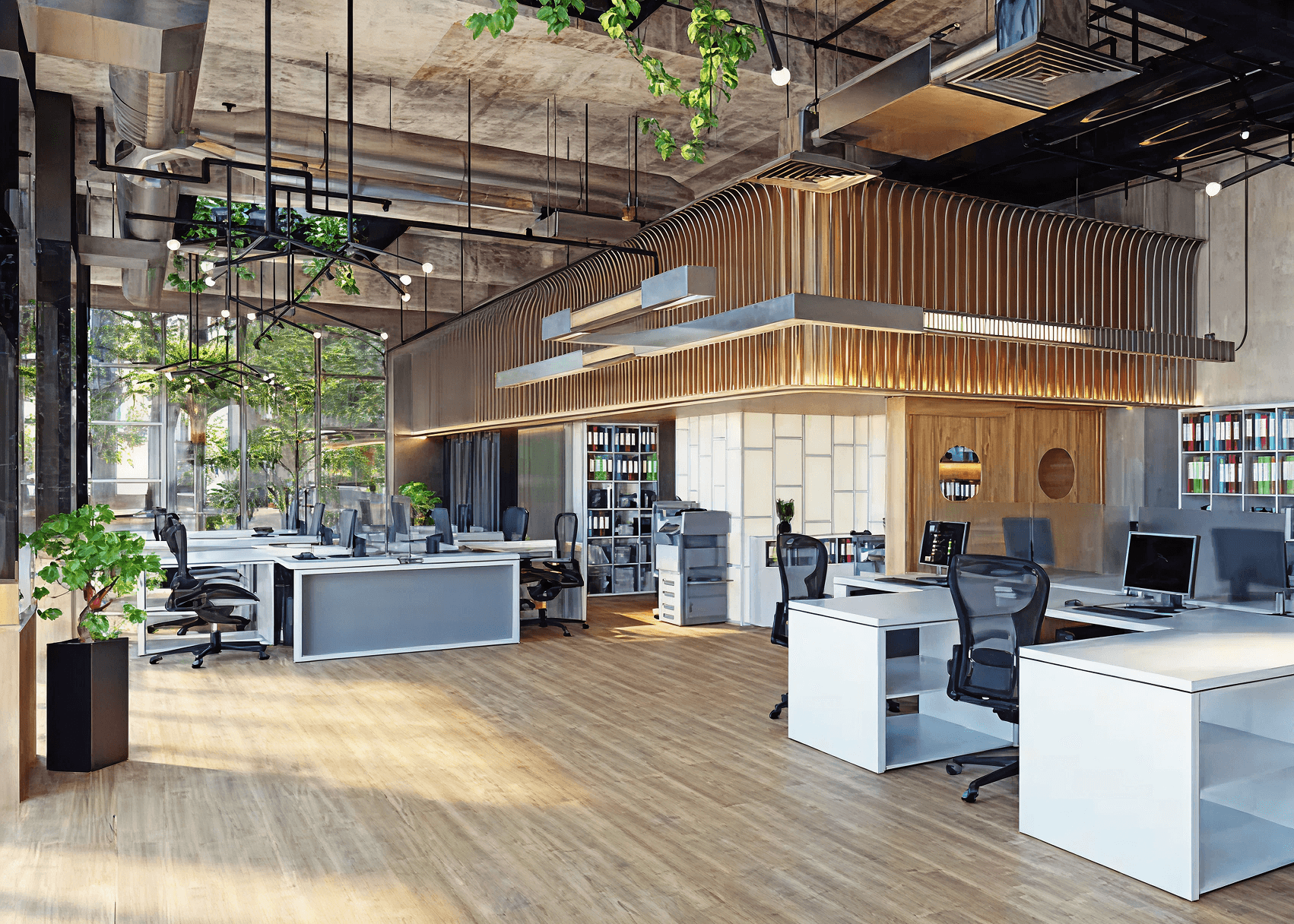 Modern office with open layout features sleek desks and chairs, abundant natural light from large windows, exposed ceiling pipes, and greenery, creating a fresh, airy vibe.