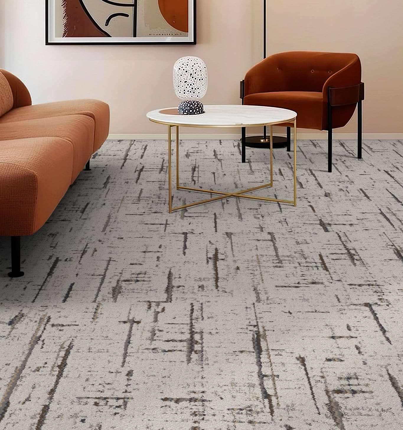 Modern living room with a warm tone. Features a brown sofa and chair, round table with a decorative piece, abstract wall art, and patterned carpet.