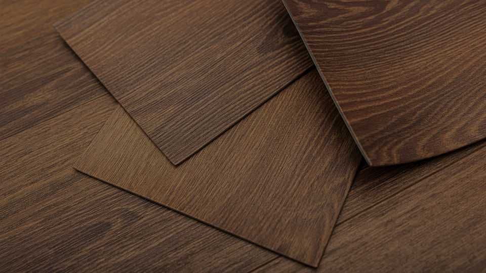 Close-up of overlapping wooden vinyl planks with rich brown tones and wood grain texture, conveying a warm, earthy, and natural aesthetic.
