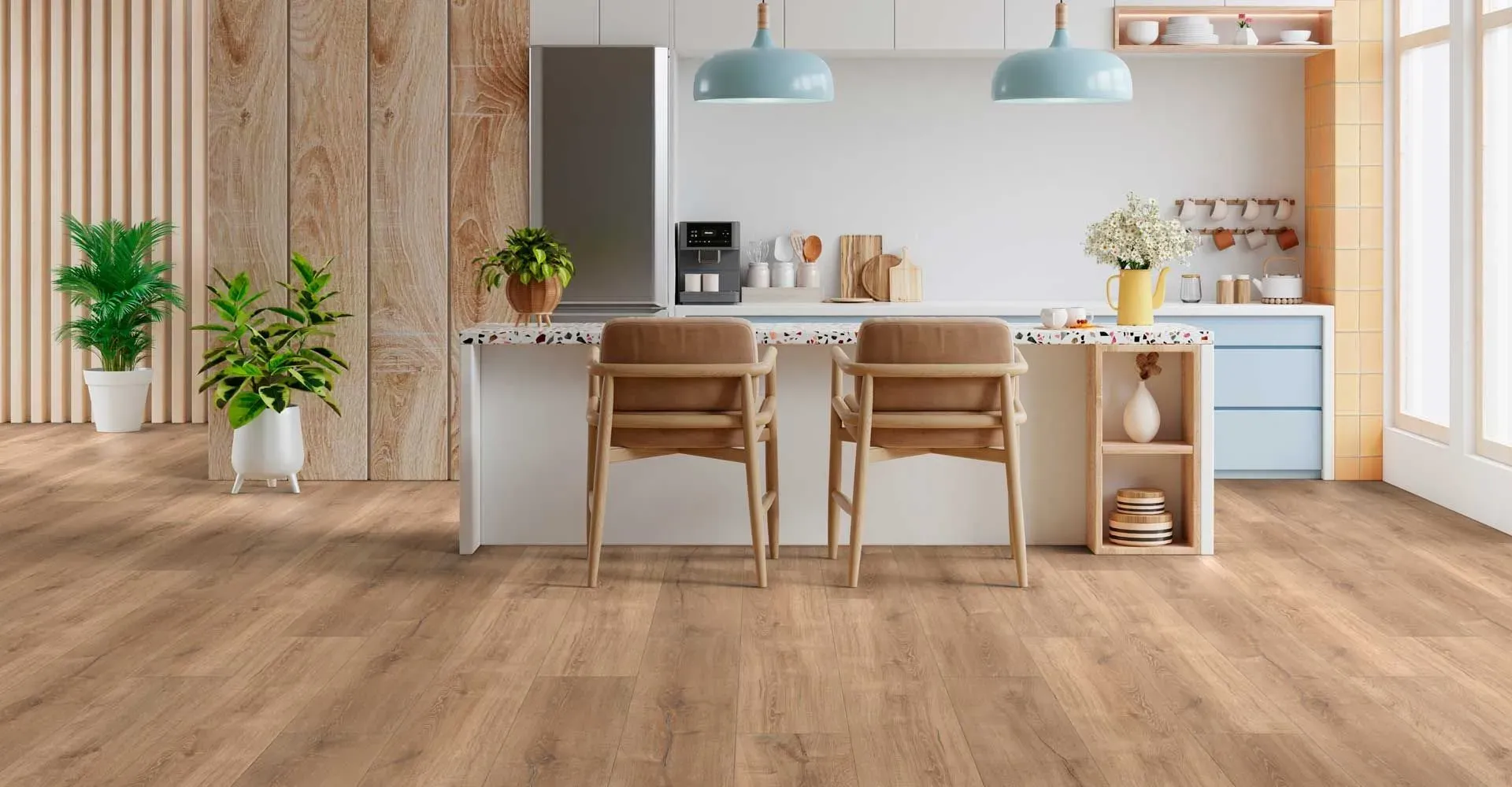 A modern kitchen features light wood flooring, two wooden stools at a white island, teal pendant lights, and green plants, creating a cozy, fresh feel.